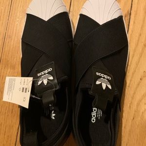Black Adidas slip-ons